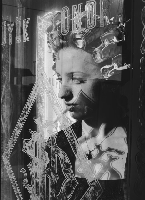 The Woman in Curlers Looking out a Window The Woman in Curlers Looking out a Window