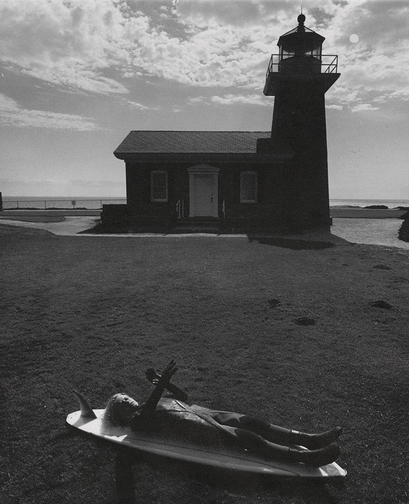 Lighthouse with Child Lying on Surfboard (Surfer's Dream)